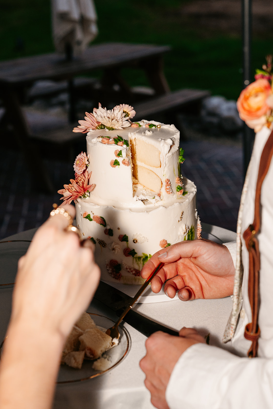 Candid wedding cake cutting picture at Norse Flora farmhouse venue